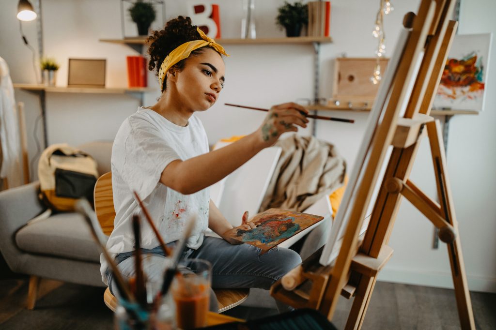 Photo of young female artist in her apartment