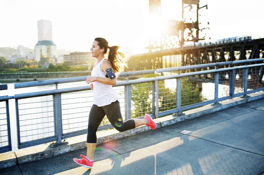 woman running on a bridge