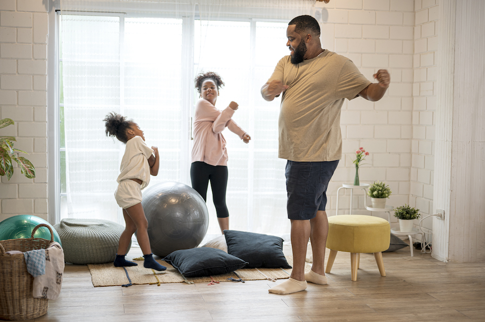 Father and his two daughter morning exercise at home.