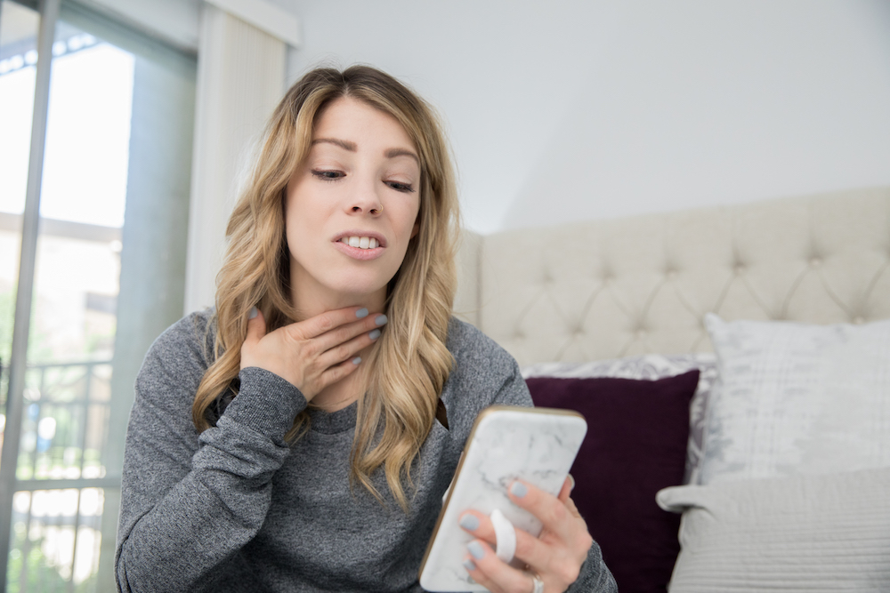 Adult female explaining illness to doctor online via video chat