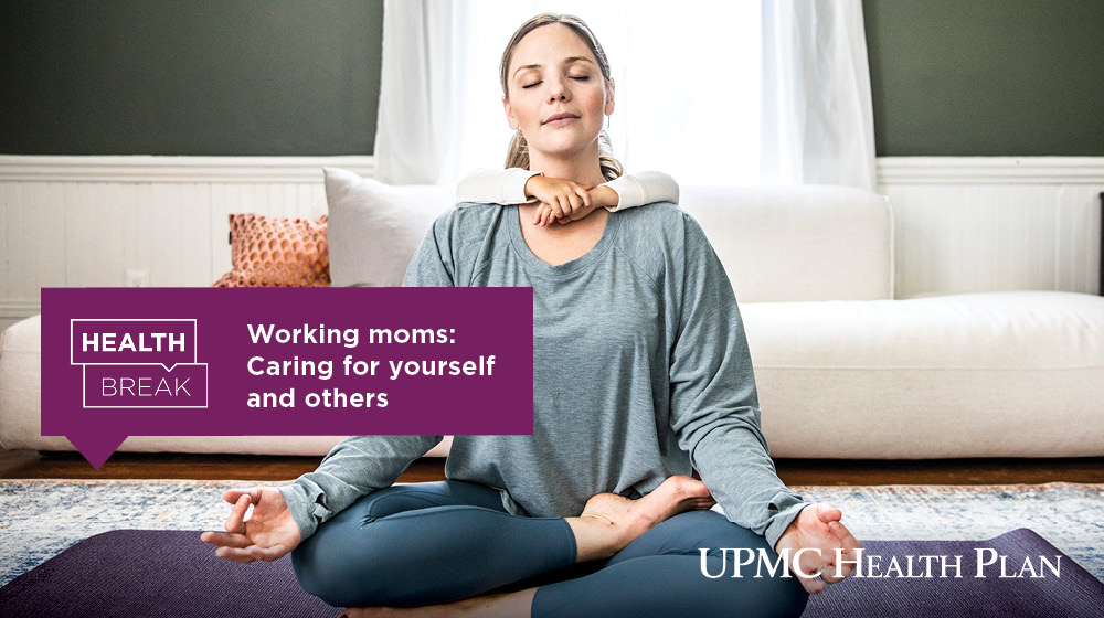 A working mom sitting in a yoga pose with their child's arms wrapped around their shoulders
